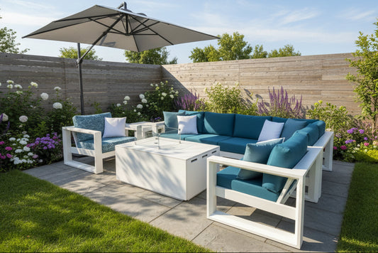 Outdoor furniture set with teal cushions and white frames on a patio.