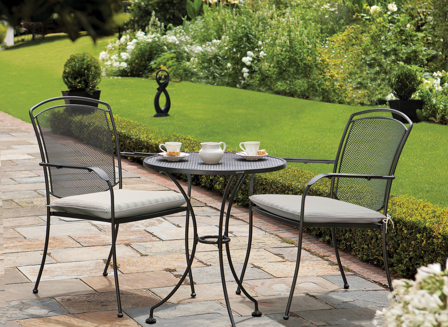 Kettler Henley Outdoor Dining Arm Chai around a table