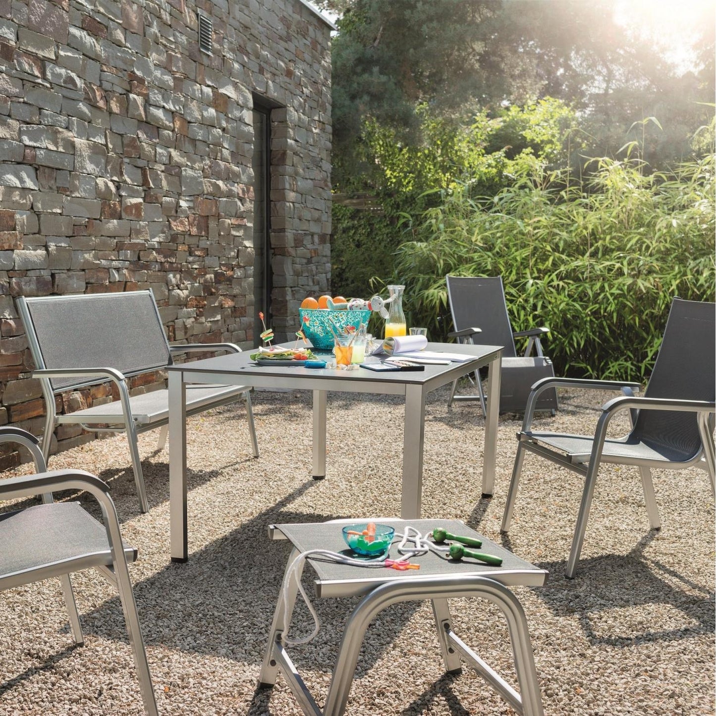 Kettler Basic Plus Outdoor Ottoman around the table and chairs